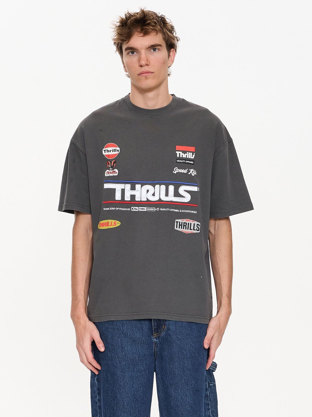 Male model wearing our Thrills Rapid Response Box Fit Oversize Tee in Black standing against a plain studio background.