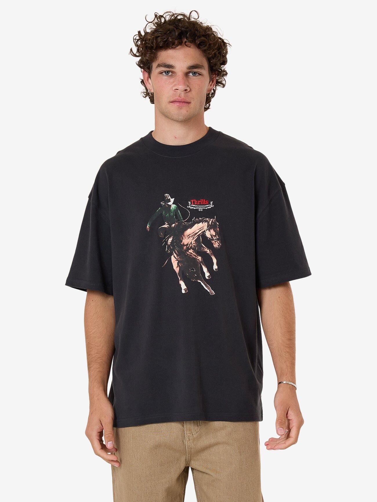 Male model wearing our Thrills Eternal Outlaw Box Fit Oversize Tee in Black standing against a plain studio background.