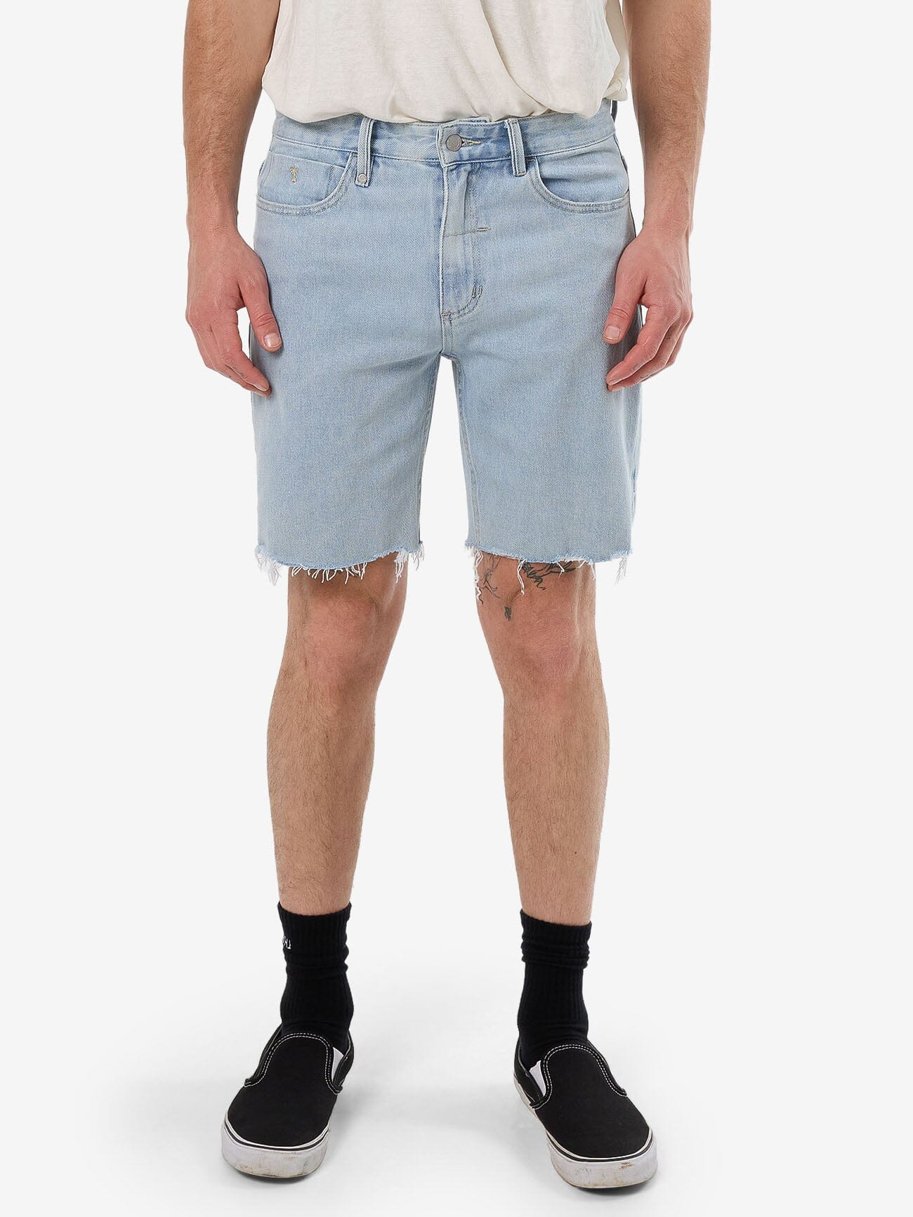 Male model wearing our Thrills Bones Denim Short in Blue standing against a plain studio background.