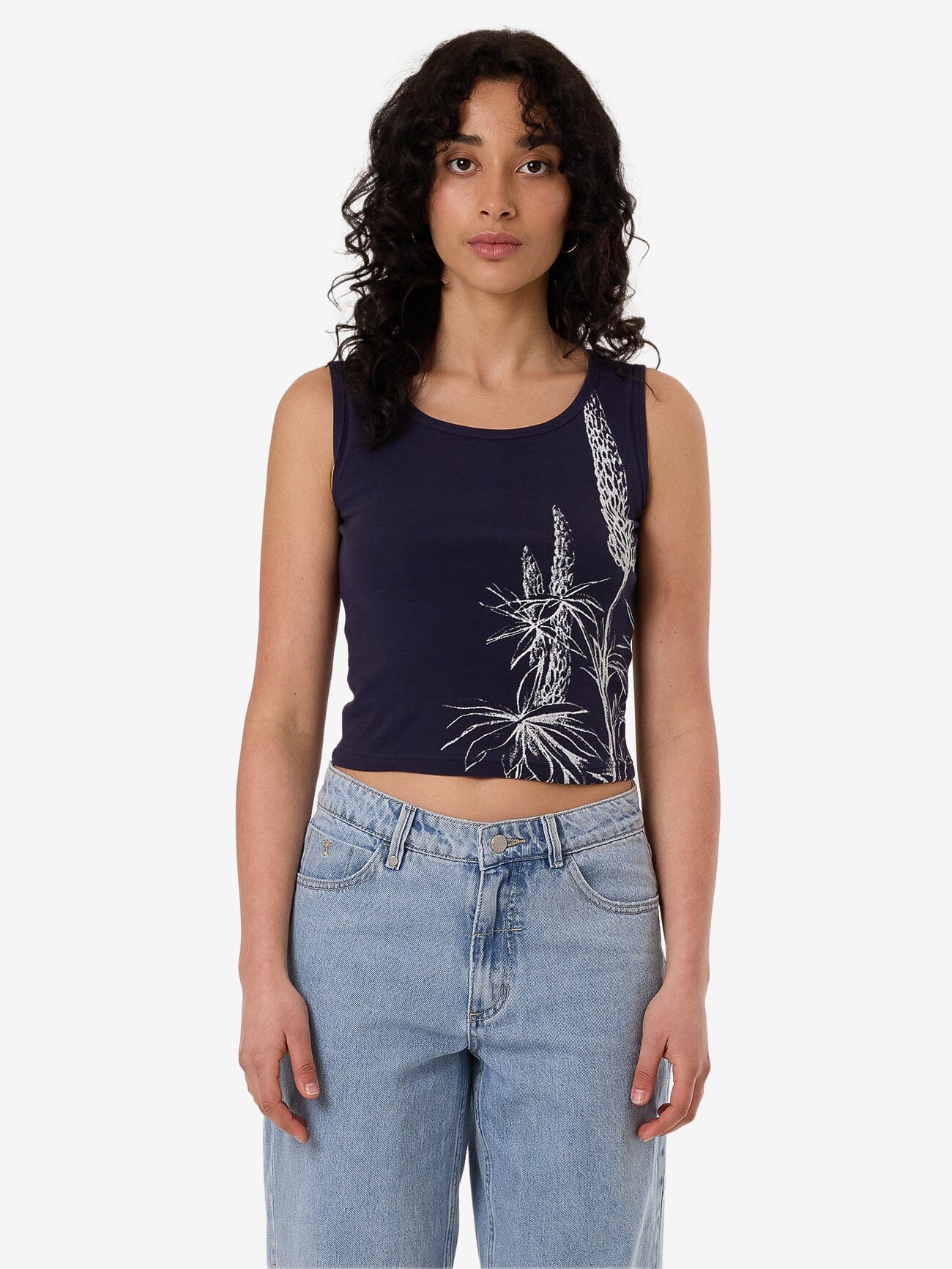 Female model wearing our Thrills Lupin Y2K Tank in Blue standing against a plain studio background.