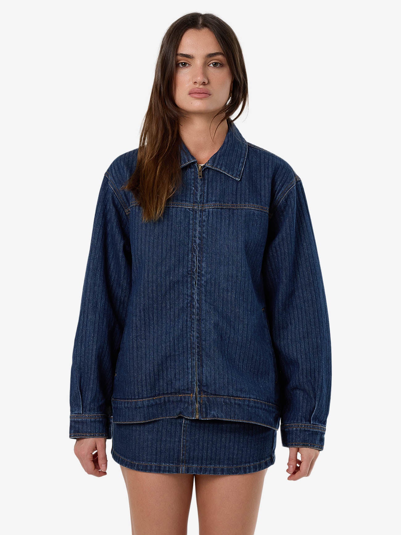 Female model wearing our Thrills Hayden Jacket in Blue standing against a plain studio background.