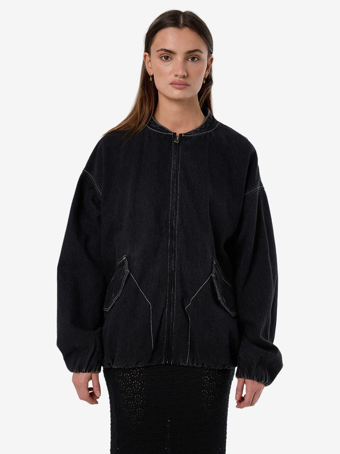 Female model wearing our Thrills Rayne Oversized Bomber in Black standing against a plain studio background.