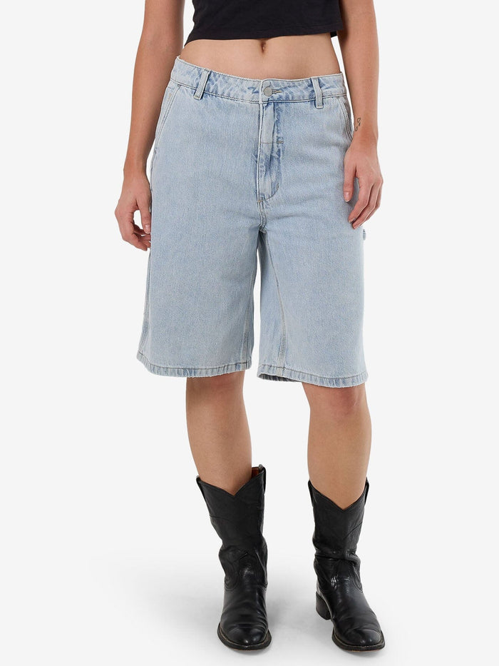 Female model wearing our Thrills Slouch Carpenter Short in Blue standing against a plain studio background.