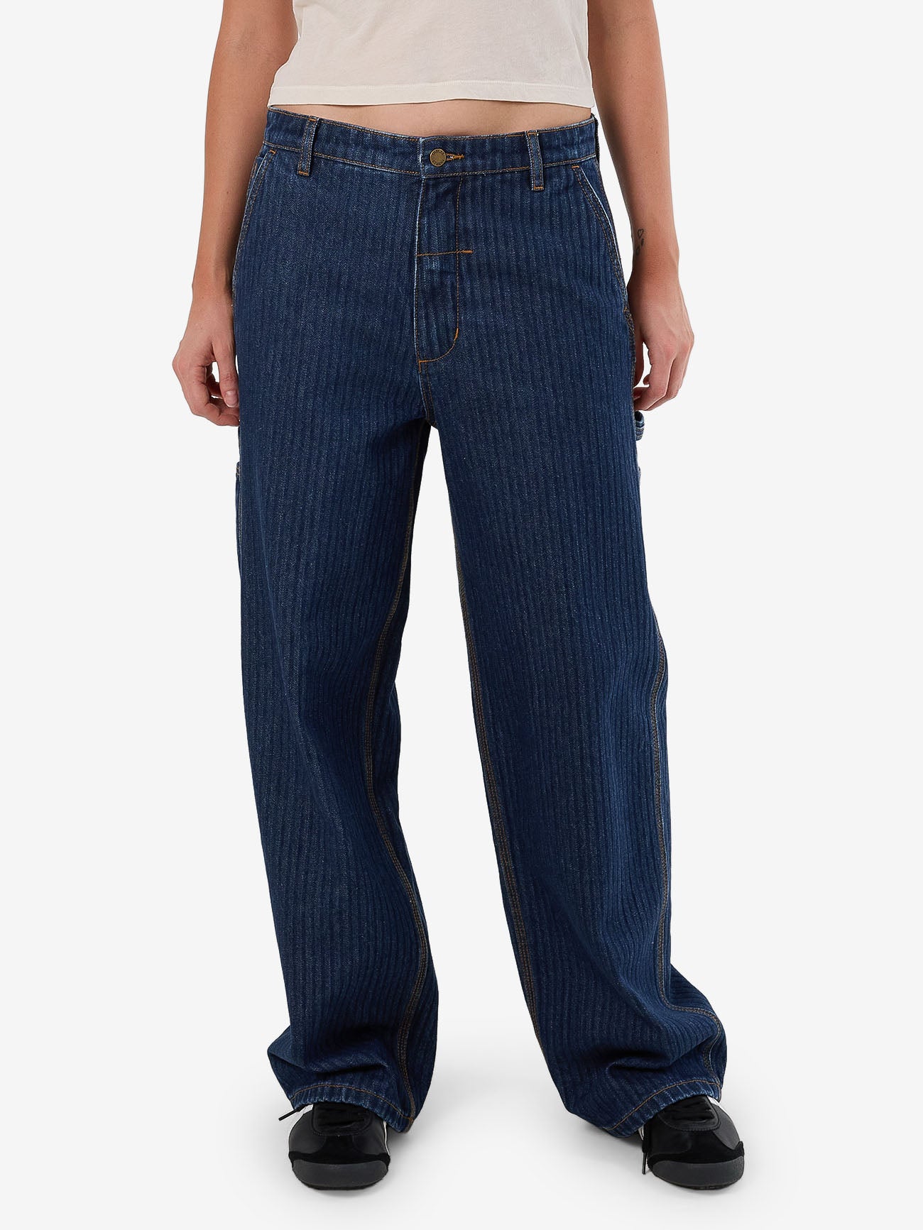 Female model wearing our Thrills Slouch Carpenter Jean in Blue standing against a plain studio background.