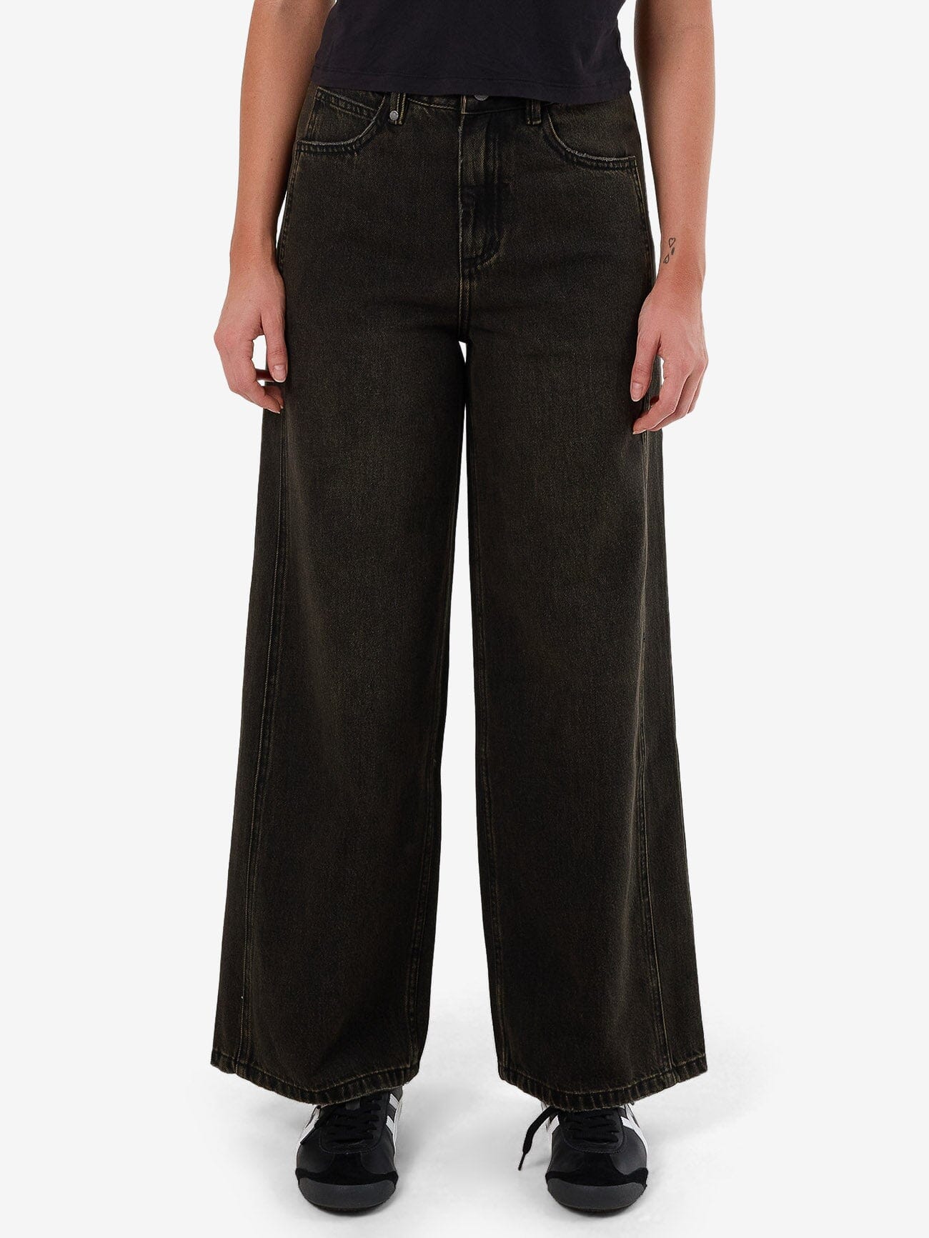 Female model wearing our Thrills Ashton Jean in Black standing against a plain studio background.