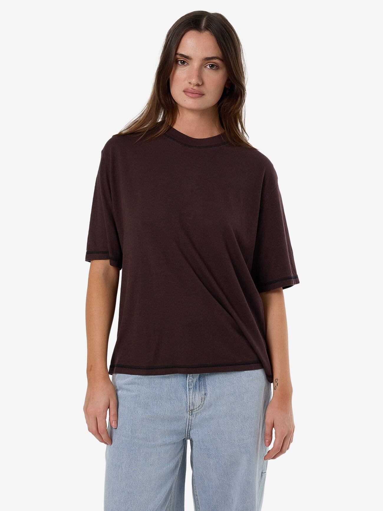 Female model wearing our Thrills Hemp Square Tee in Brown standing against a plain studio background.