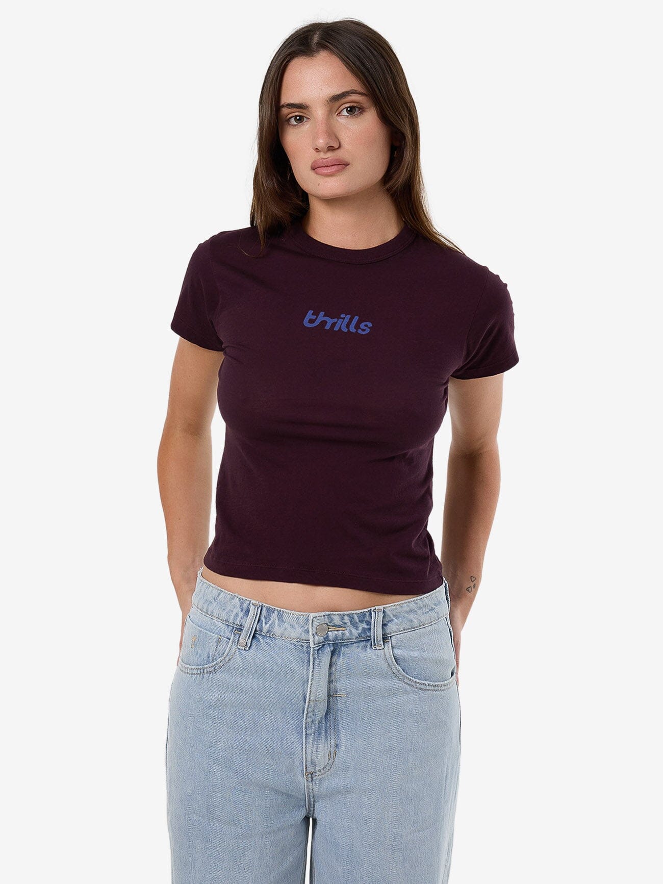 Female model wearing our Thrills Cracked Boy Tee in Red standing against a plain studio background.