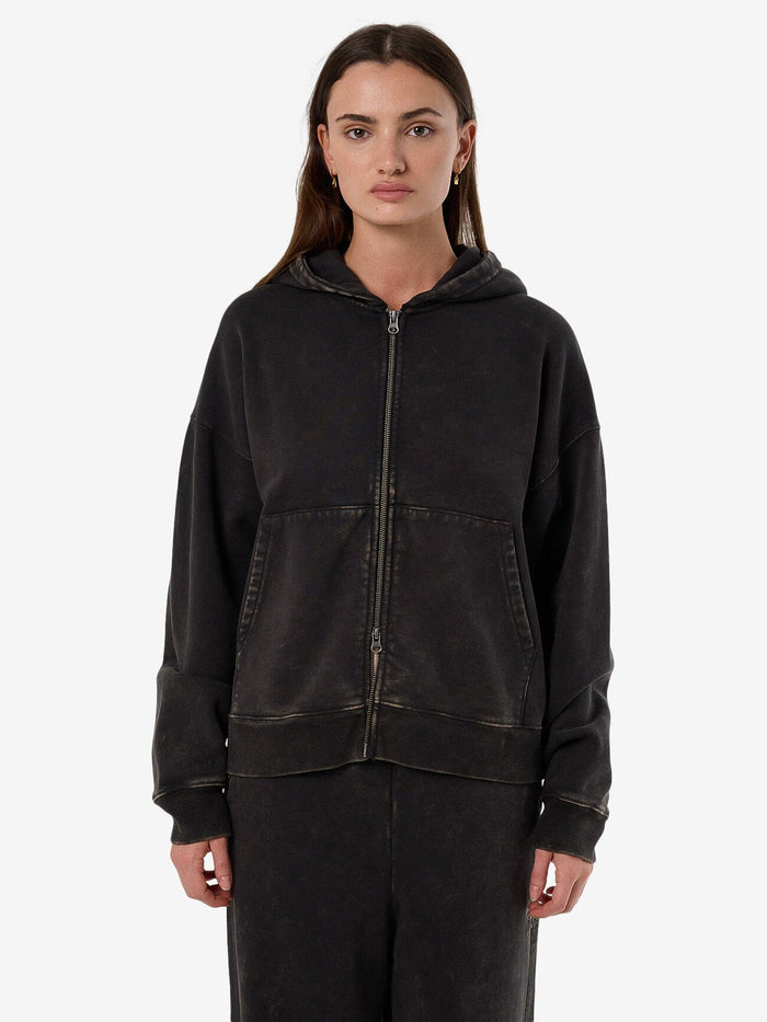 Female model wearing our Thrills Dissolve Zip Hood Fleece in Grey standing against a plain studio background.