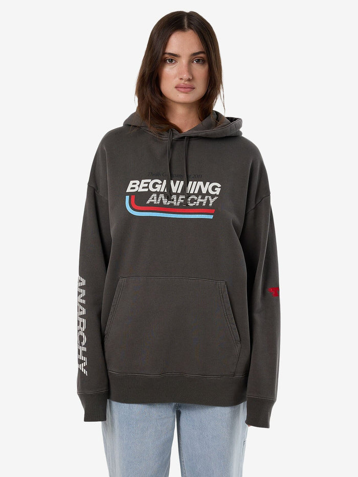 Female model wearing our Thrills Beginning Anarchy Slouch Hood in Black standing against a plain studio background.