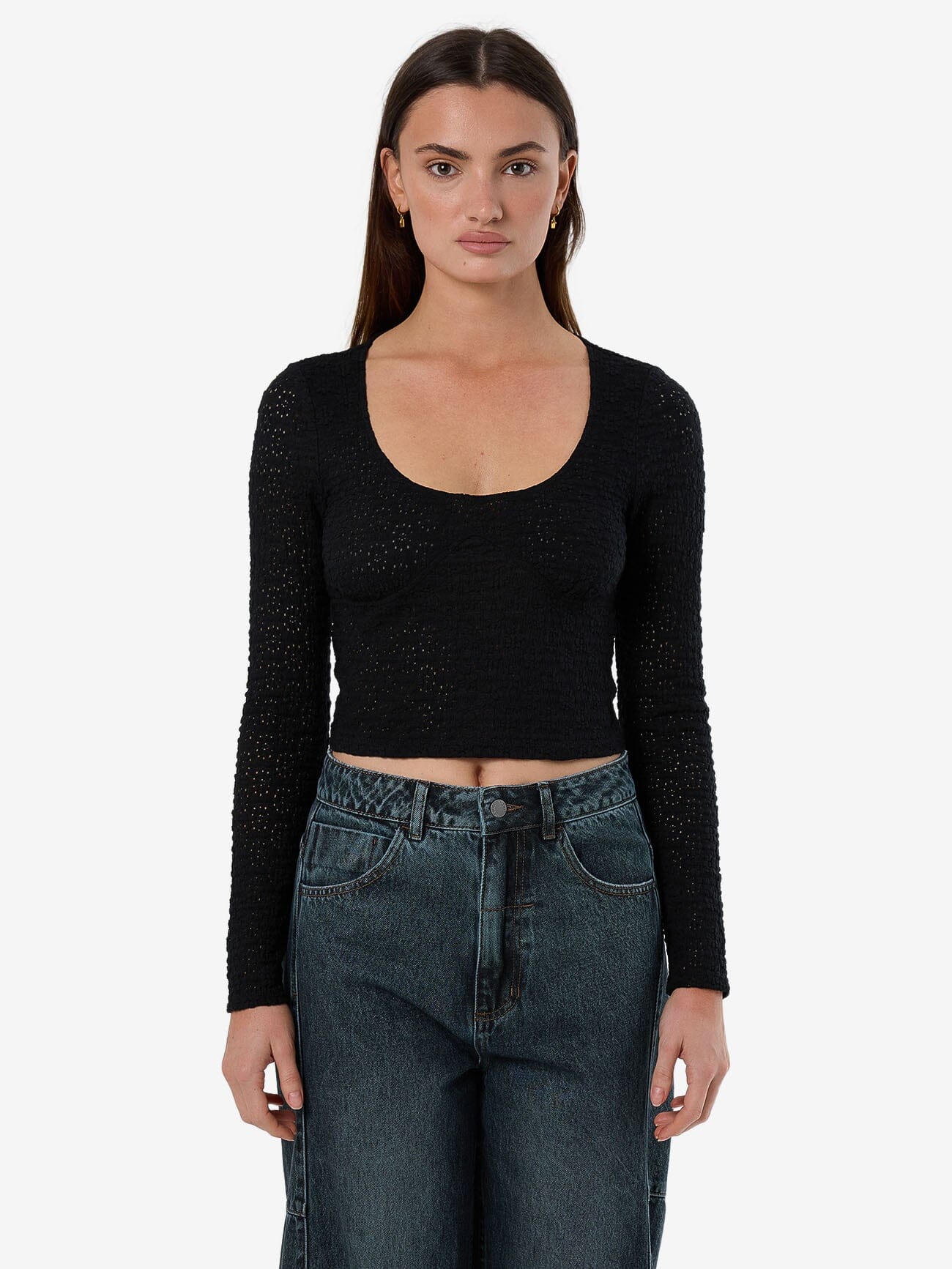 Female model wearing our Thrills Montanna Lace Top in Black standing against a plain studio background.