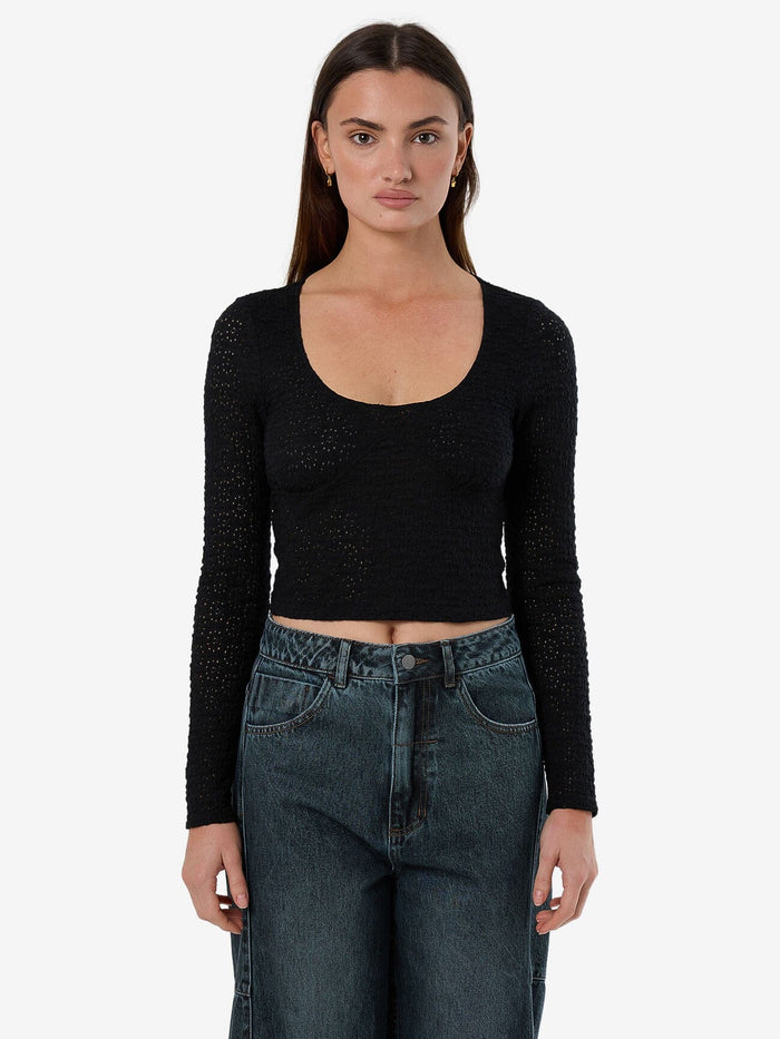 Female model wearing our Thrills Montanna Lace Top in Black standing against a plain studio background.