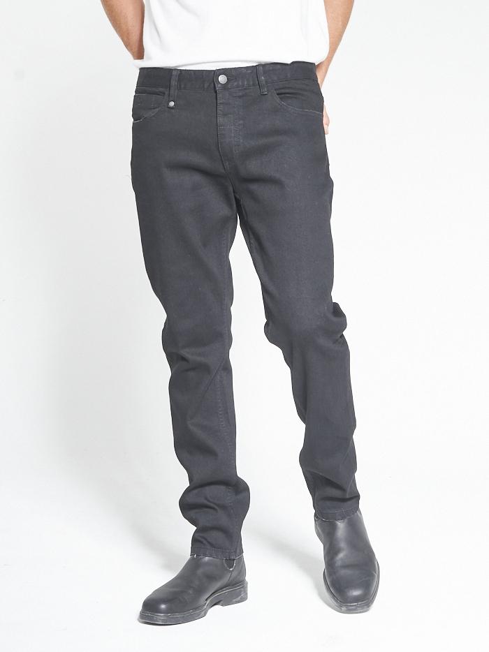 Male model wearing our Thrills Bones Denim Jean in Black standing against a plain studio background.