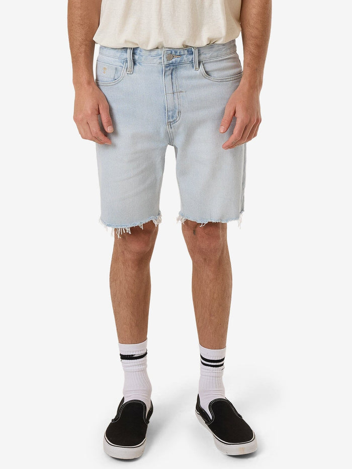 Male model wearing our Thrills Bones Denim Short in Blue standing against a plain studio background.