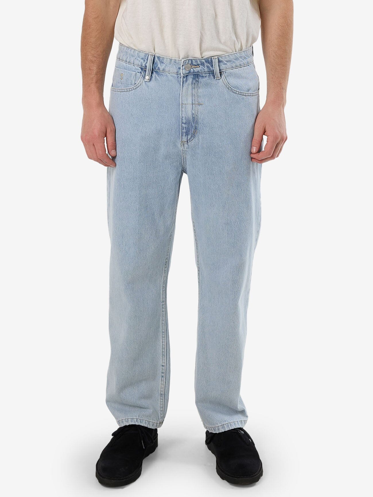 Male model wearing our Thrills Slacker Denim Jean in Blue standing against a plain studio background.