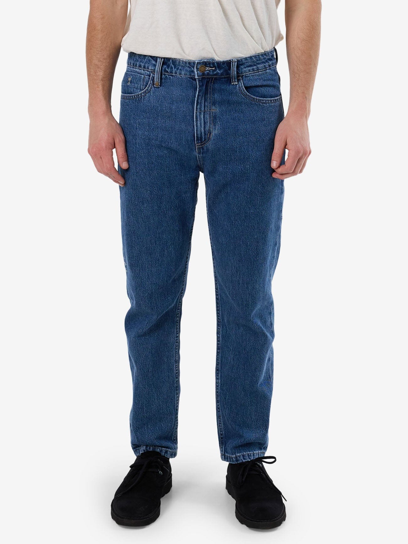 Male model wearing our Thrills Unchopped Denim Jean in Blue standing against a plain studio background.