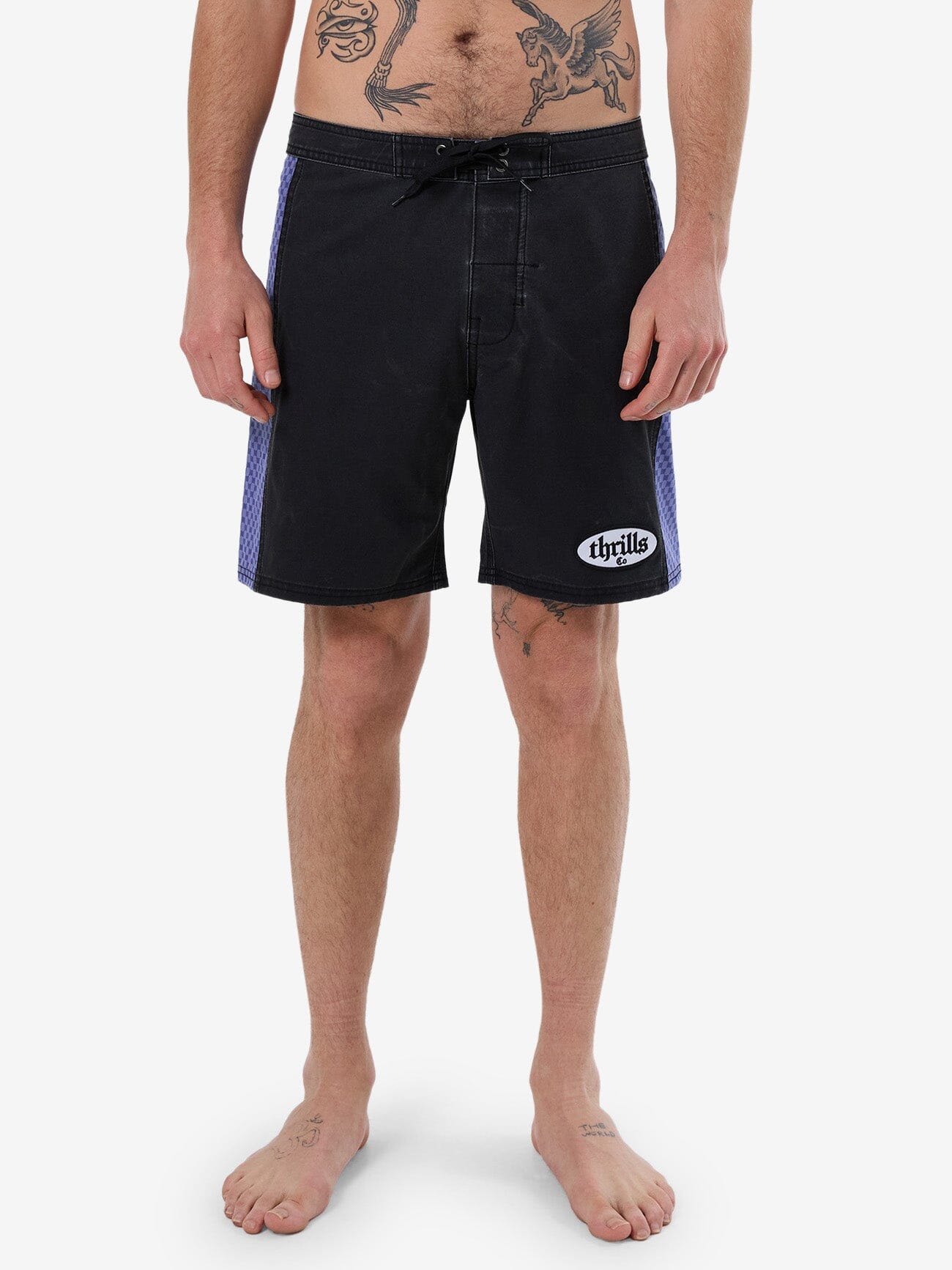 Male model wearing our Thrills Lifted Spirits Boardshort in Black standing against a plain studio background.