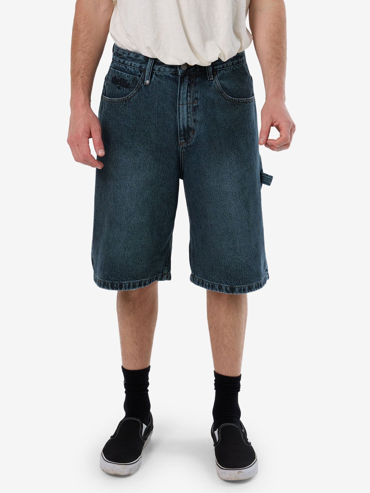 Male model wearing our Thrills Lifted Spirits Big Slacker Denim Short in Blue standing against a plain studio background.