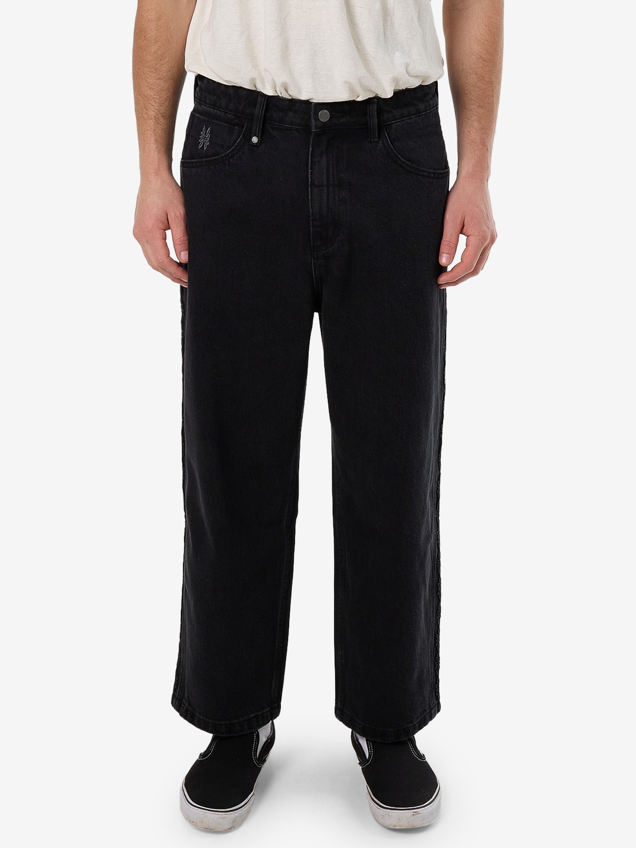 Male model wearing our Thrills Lighten Up Big Slacker Cropped Denim Jean in Black standing against a plain studio background.