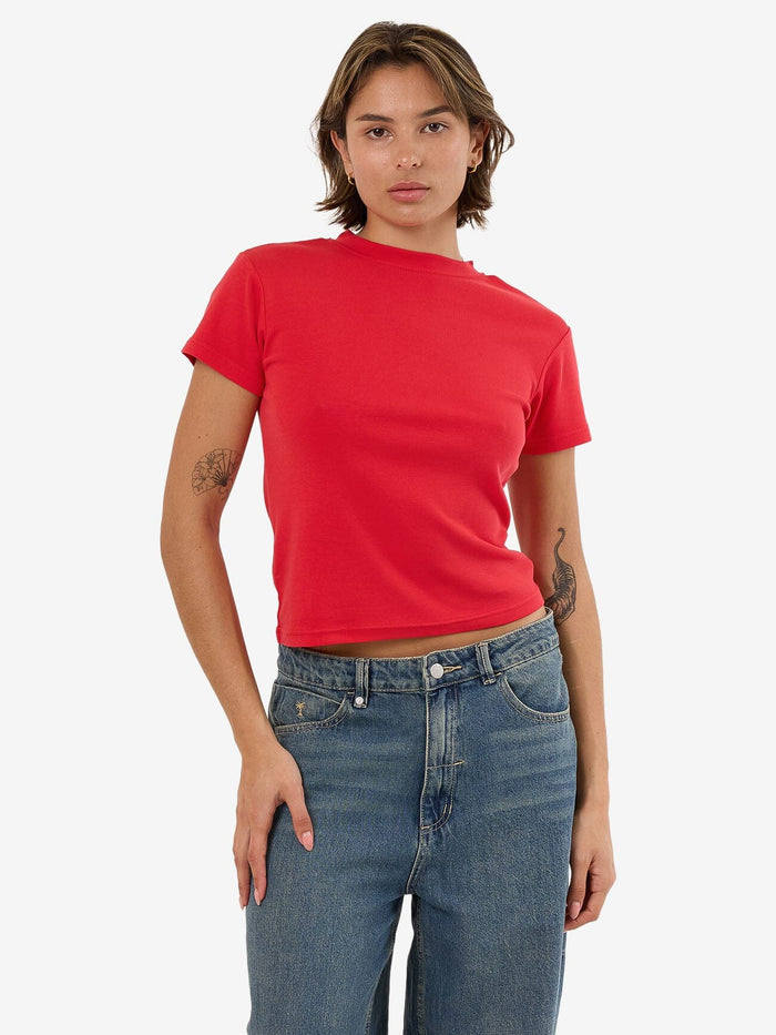 Female model wearing our Thrills Thrills Boy Tee in Red standing against a plain studio background.