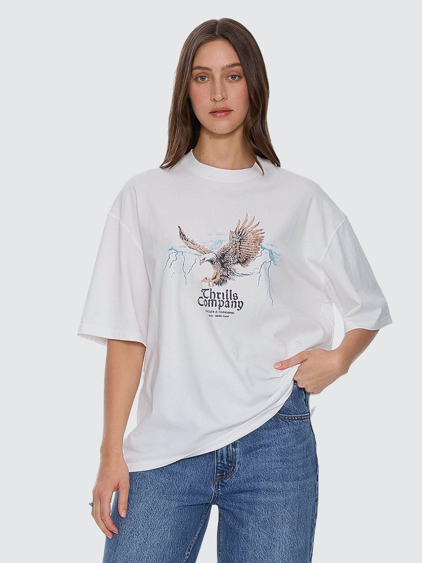 Person wearing a white t-shirt with a graphic design and blue jeans on a white background