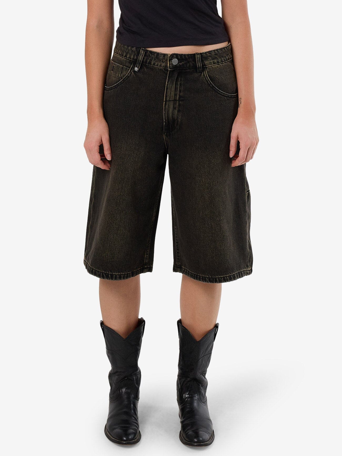 Female model wearing our Thrills Darcy Short in Black standing against a plain studio background.
