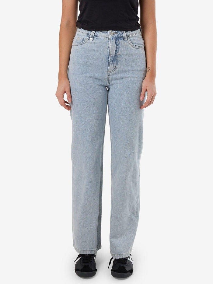Female model wearing our Thrills Cherry Stretch Jean in Blue standing against a plain studio background.