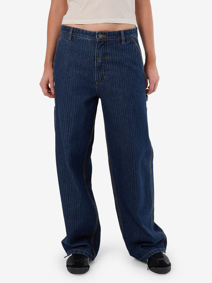 Female model wearing our Thrills Slouch Carpenter Jean in Blue standing against a plain studio background.