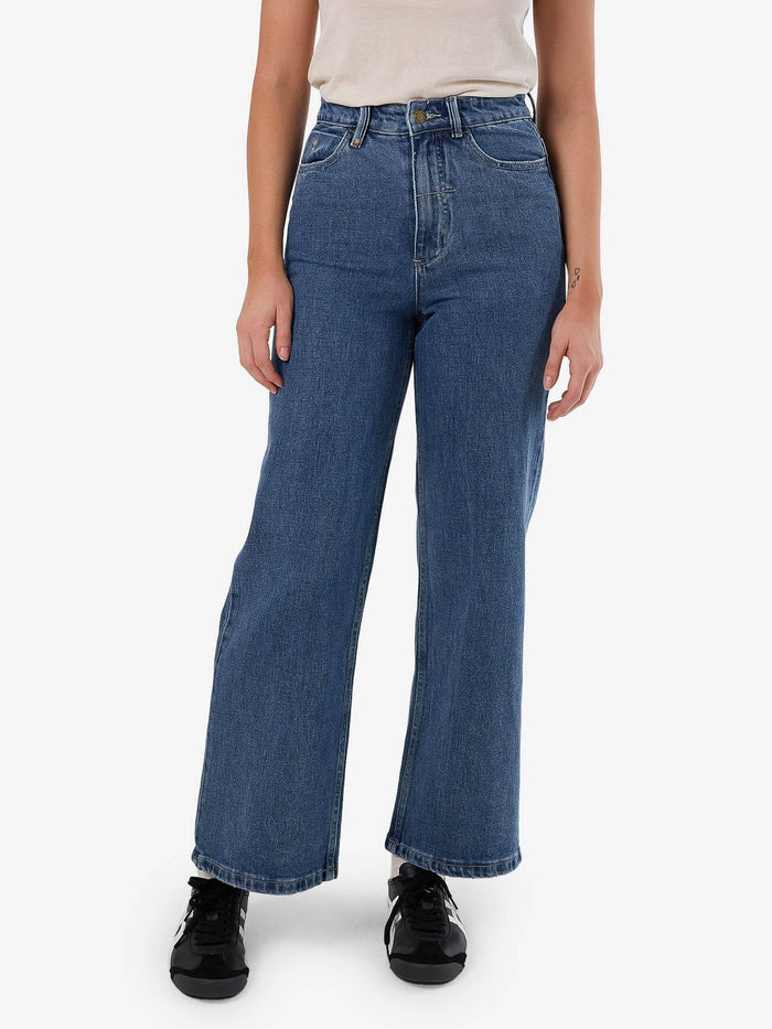 Female model wearing our Thrills Holly Stretch Jean in Blue standing against a plain studio background.