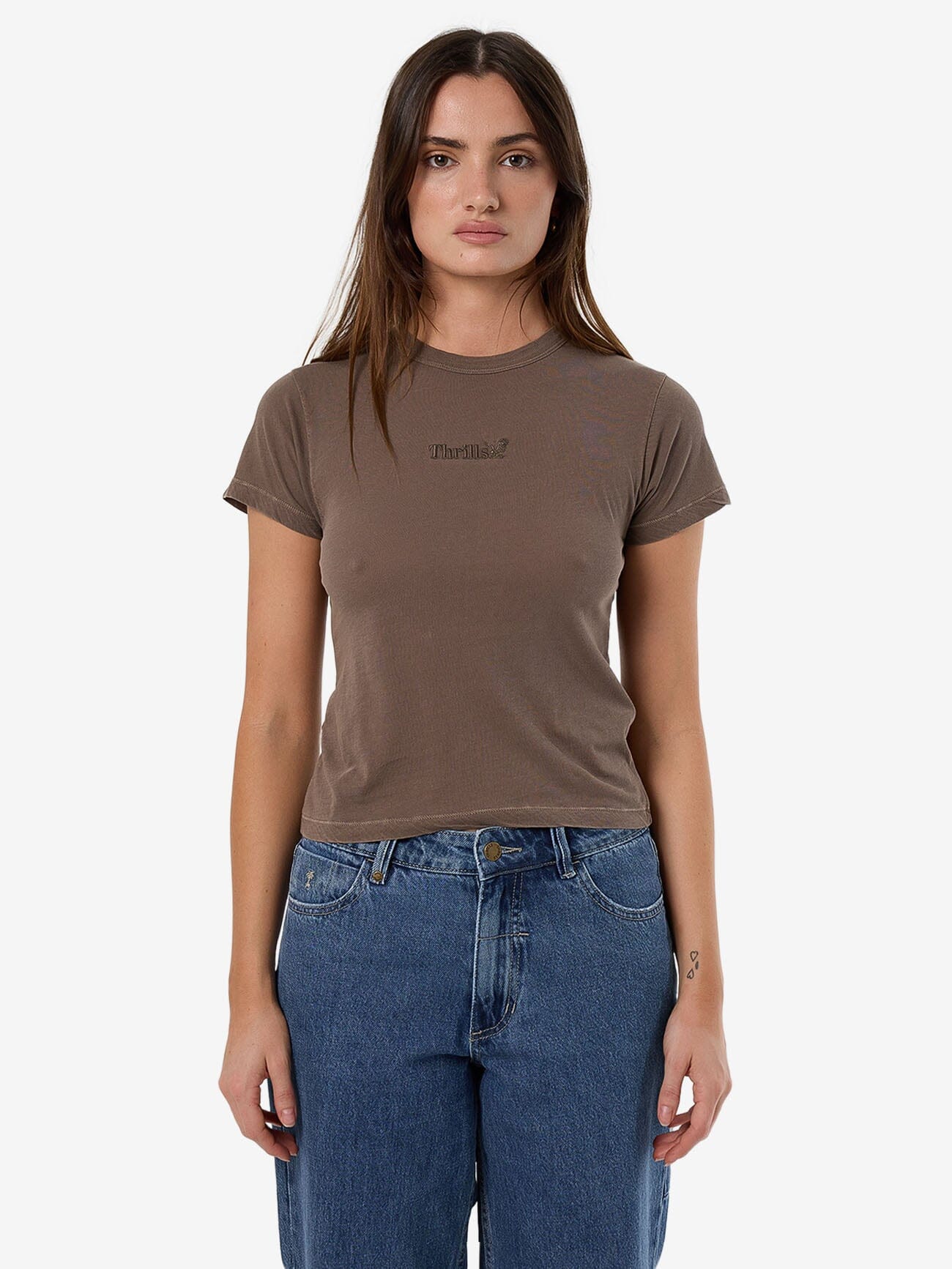 Female model wearing our Thrills Thrills Workwear Boy Tee in Brown standing against a plain studio background.