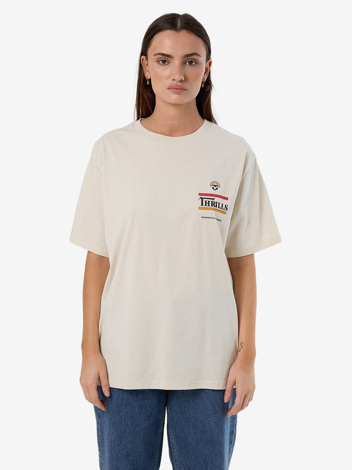 Female model wearing our Thrills Responsible Thrills Merch Tee in White standing against a plain studio background.