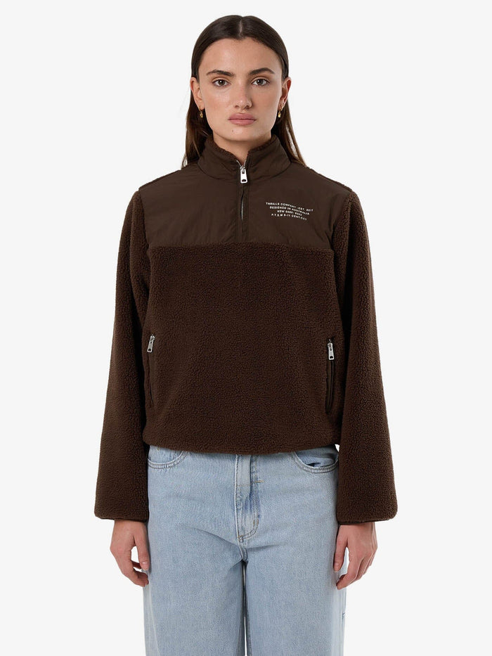 Female model wearing our Thrills Warm Down Polar Fleece in Brown standing against a plain studio background.