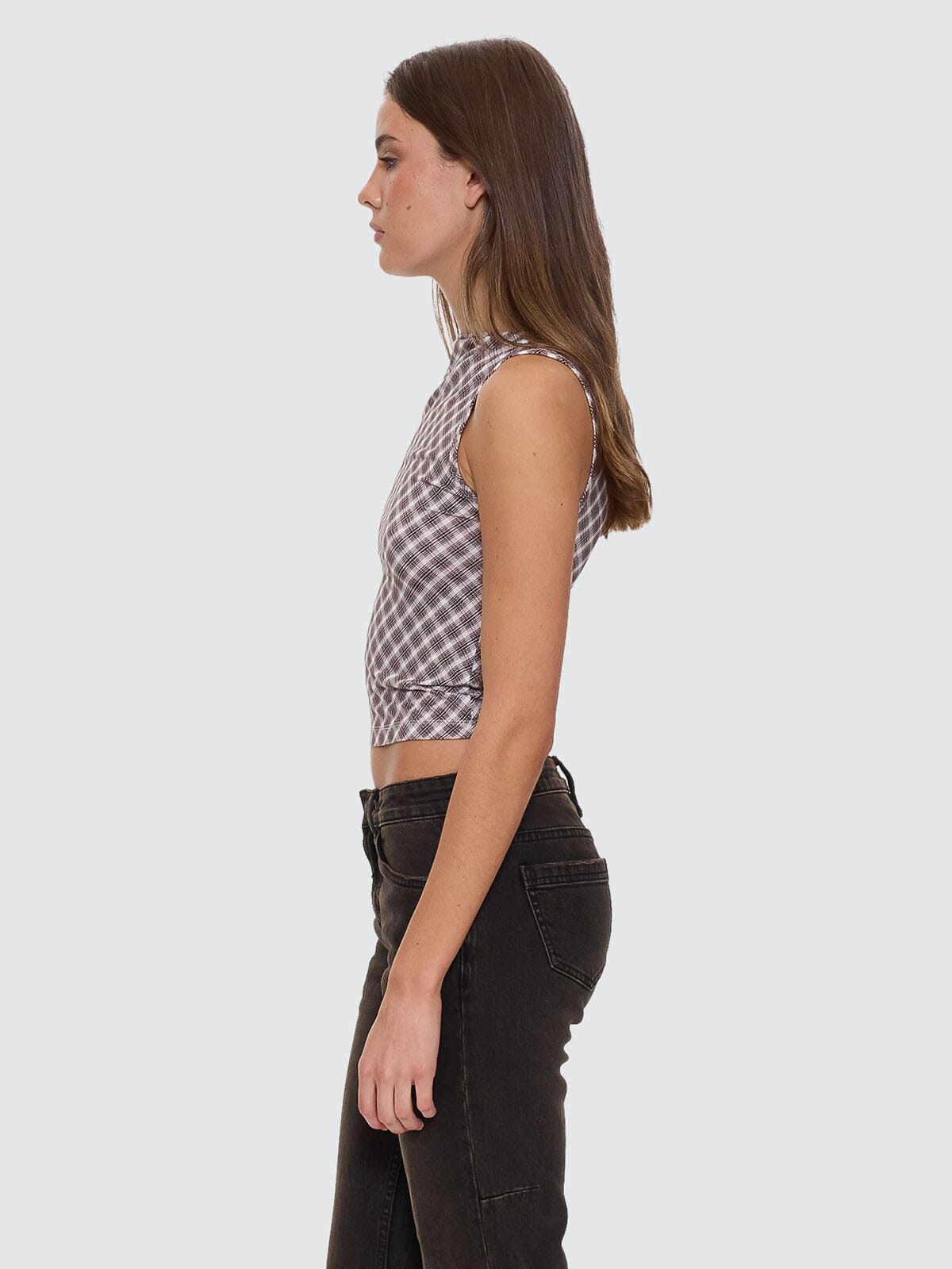 Female model wearing our Thrills Adorned Check Tank in Brown standing against a plain studio background.