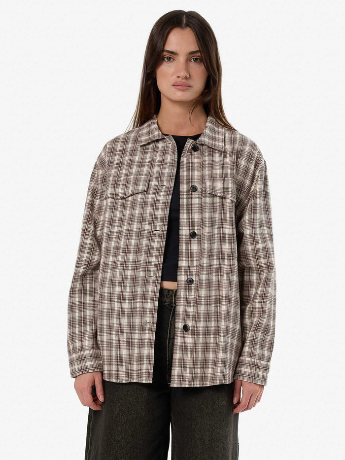 Female model wearing our Thrills Adorned Check Over Shirt in Brown standing against a plain studio background.