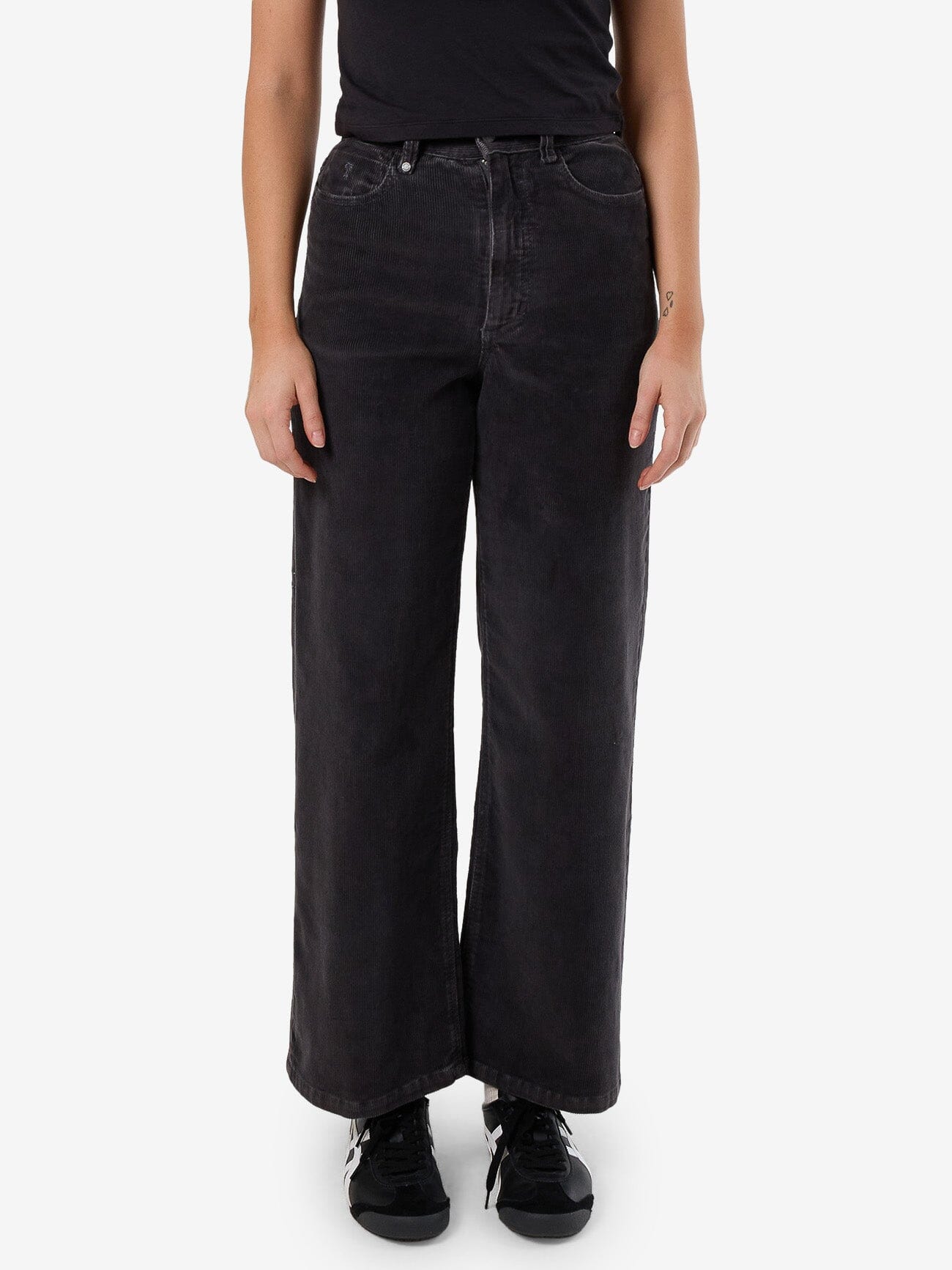 Female model wearing our Thrills Holly Cord Pant in Grey standing against a plain studio background.