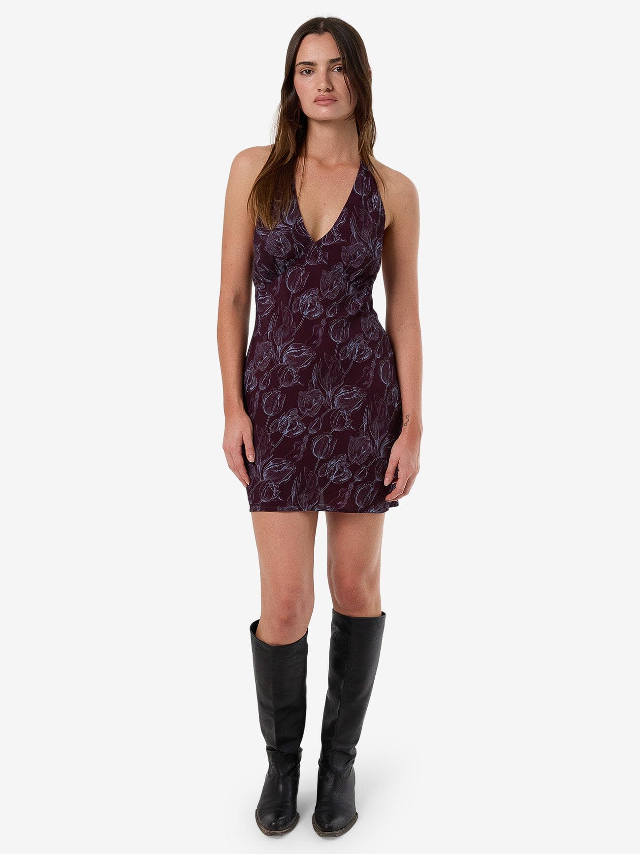 Female model wearing our Thrills Oracle Floral Halter Mini Dress in Red standing against a plain studio background.