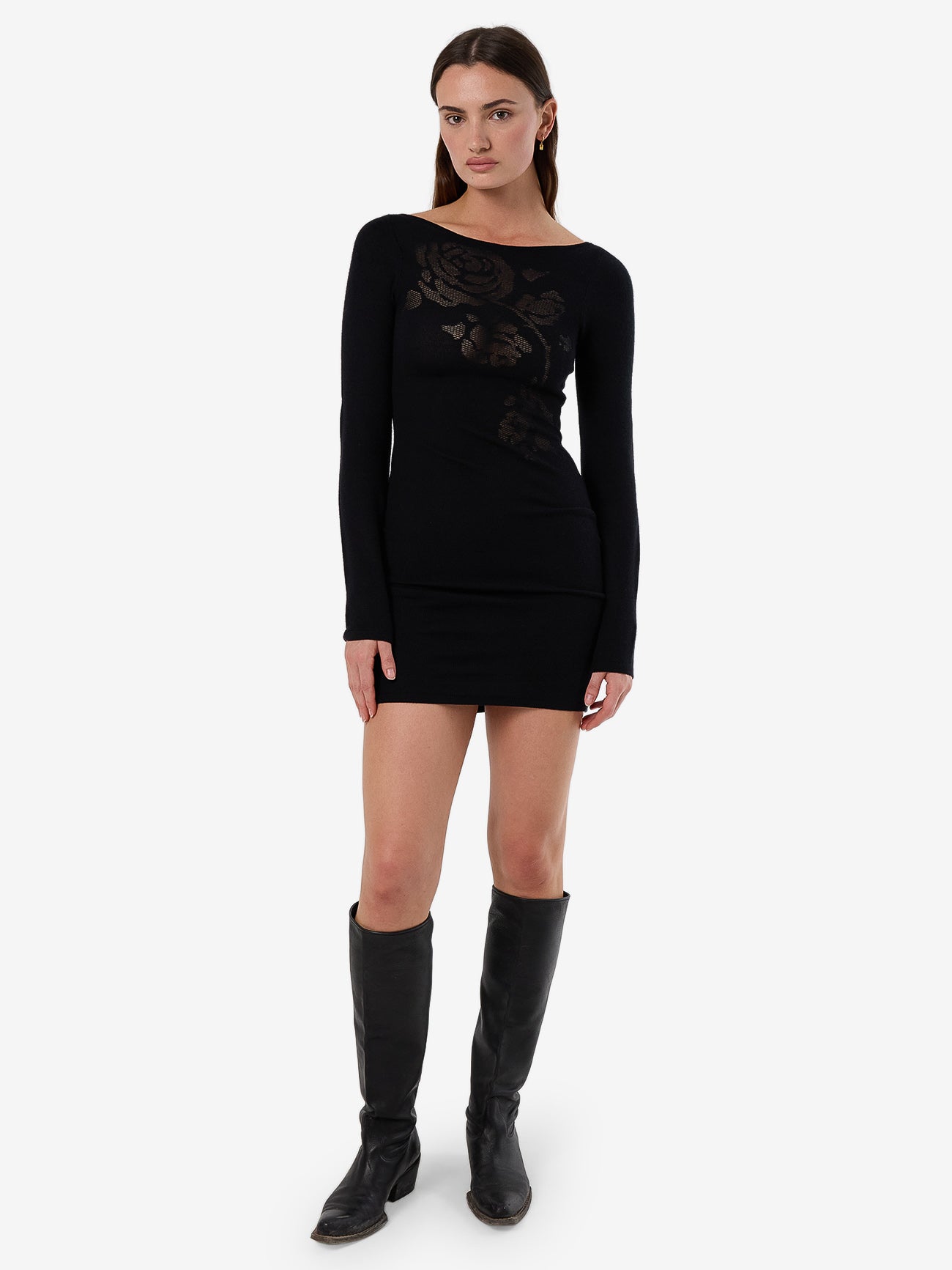 Female model wearing our Thrills Rosetta Knit Mini Dress in Black standing against a plain studio background.